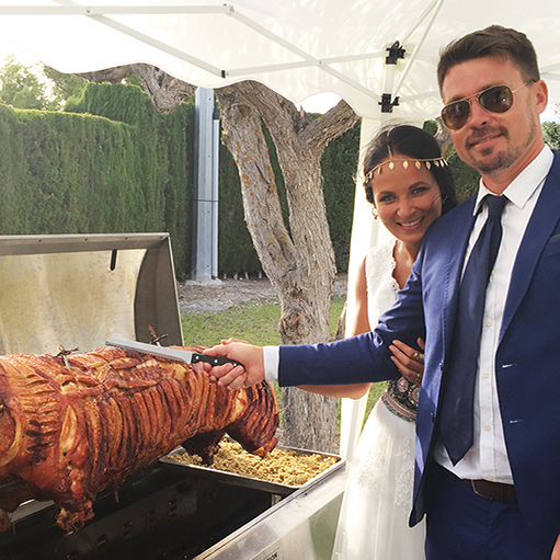 Here we see one of our happy couples about to cut the hog at their wedding